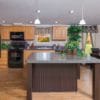 The Peyton model large kitchen island and wooden cabinets