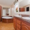 The Riley model's master bath featuring double sinks and a large bathtub