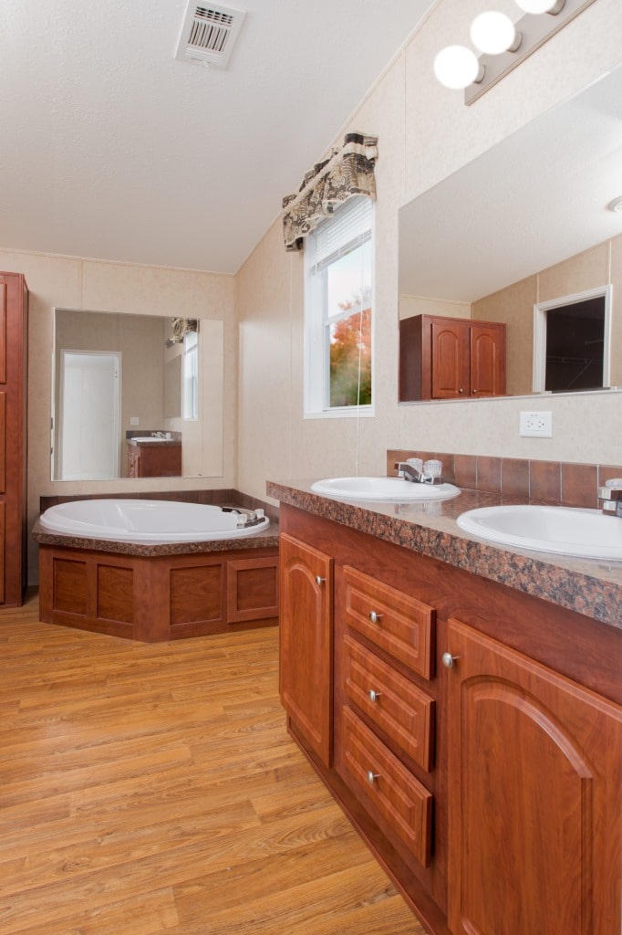 The Riley model's master bath featuring double sinks and a large bathtub