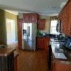 The Islander model kitchen with upgraded appliances and wood cabinets
