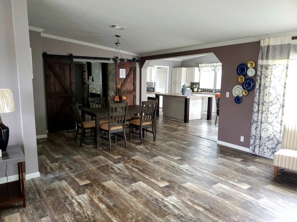 An open floor plan with a kitchen island and a dining table.